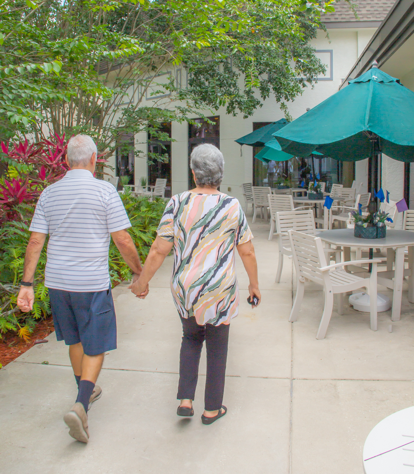 Buena Vida residents walking while holding hands