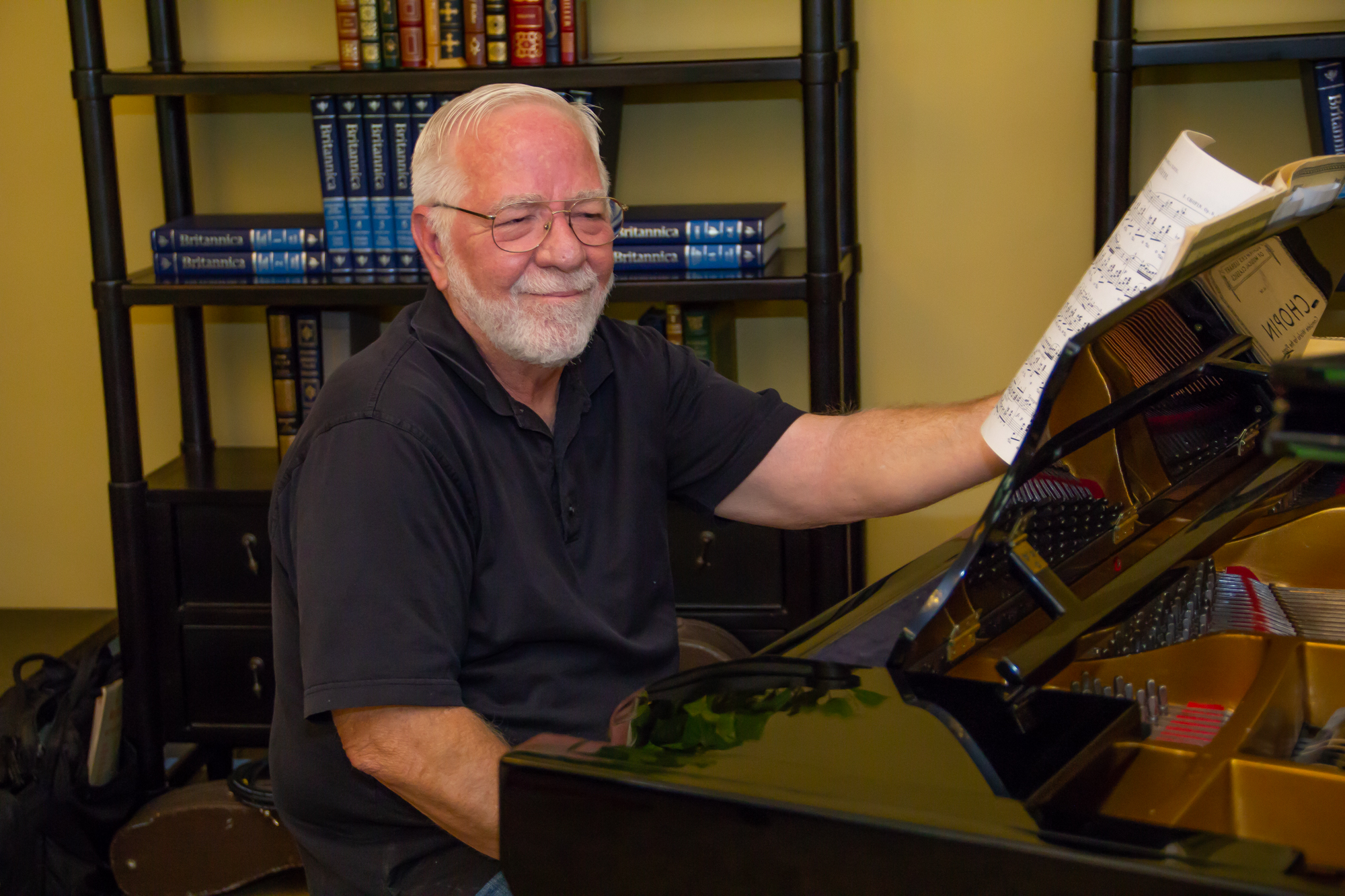 smiling Buena Vida resident playing piano