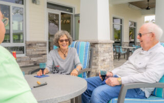 smiling residents enjoying clubhouse patio