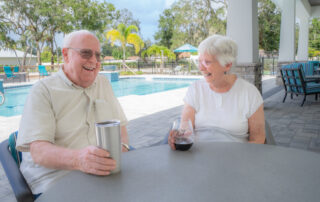 happy buena vida residents relaxing on pool patio