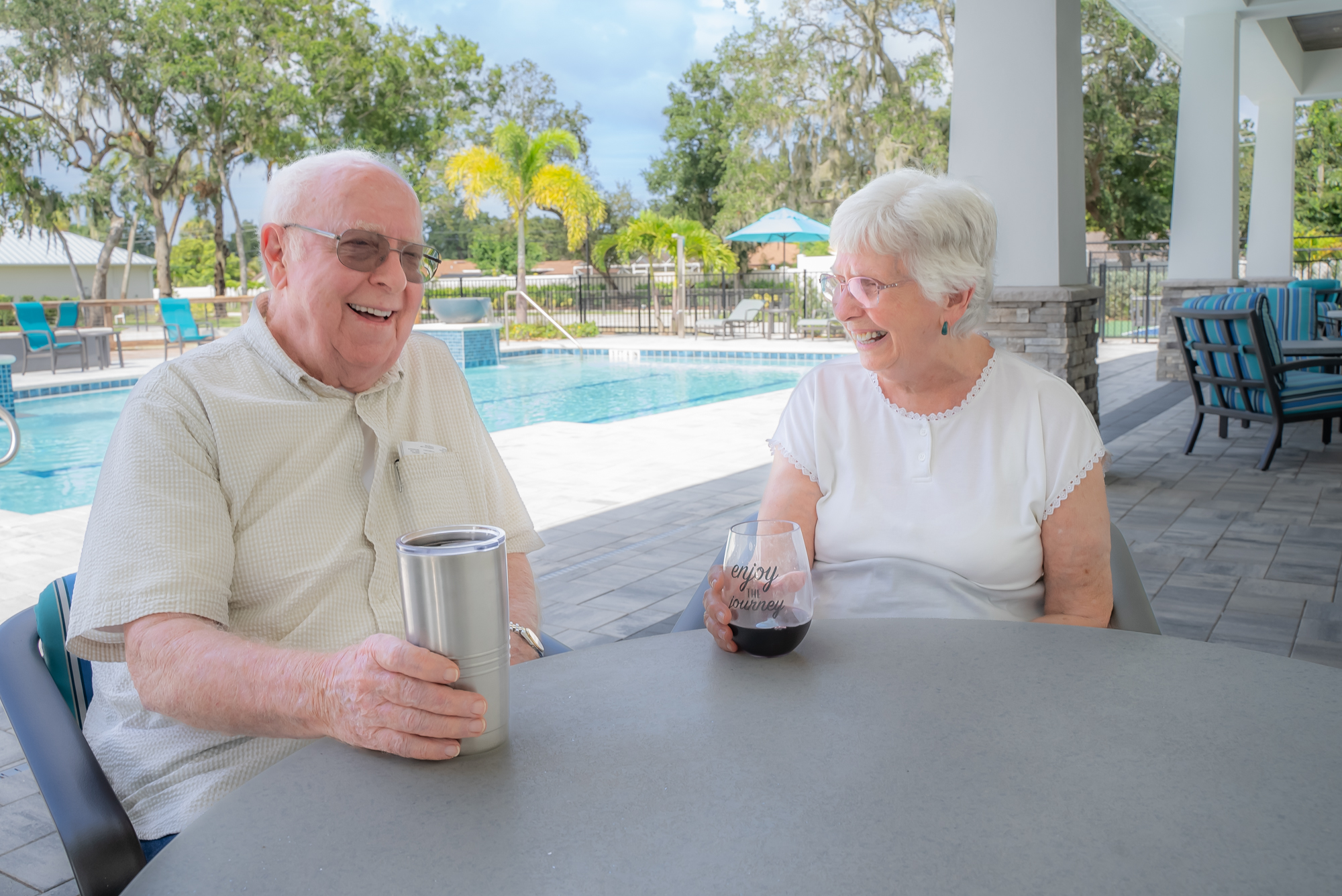 happy buena vida residents relaxing on pool patio