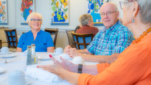 smiling residents in the dining room at buena vida estates